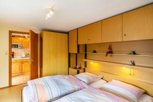 a bedroom with a bed and wooden cabinets at Bergblick in Forbach