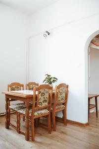 a dining room table with chairs and a wooden table at Apartmán Rybná - Kraslice in Kraslice