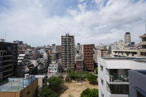 a view of a city with tall buildings at Chuan House Dotonbori in Osaka