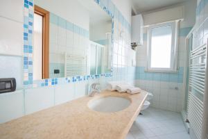 a bathroom with a sink and a toilet at APPARTAMENTI SIVIGLIA in Cattolica