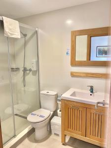 a bathroom with a shower and a toilet and a sink at Bluewater Hotel in Colònia de Sant Jordi