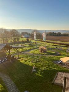 an aerial view of a large yard with a field at Ferienwohnungen auf dem Erlenhof in Beverungen