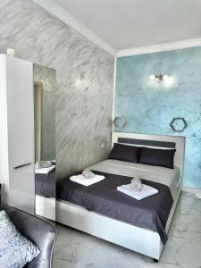 a bedroom with a bed with two towels on it at Albomi in Kotor +21 photos