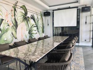 a conference room with a large table and chairs at Grand Eska Hotel & Suites Batam in Nagoya +64 photos