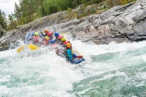 a group of people in a raft in a river at HI Sjoa in Otta +7 photos