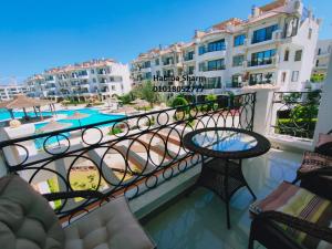 a balcony with a table and chairs and buildings at Rivera Sharm Habiba Apartments in Sharm El Sheikh