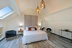 una camera da letto con un grande letto bianco e una finestra di Black Pearl Stays - Saltburn Apartments a Saltburn-by-the-Sea