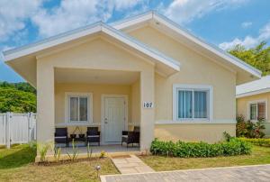 a house with a white fence at Hamilton @ Oceanpointe a serene 2bed 2 bath Villa in Lucea