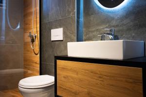 a bathroom with a sink and a toilet at Santa Quaranta Apartment 1 in Sarandë +8 photos