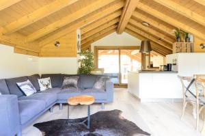 a living room with a blue couch and a table at Chalet Makalu in Les Gets