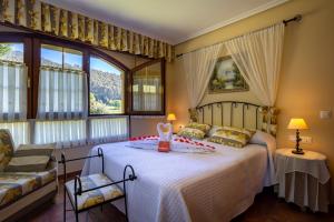 a bedroom with a bed with a cake on it at Posada El Trasmerano in Argoños