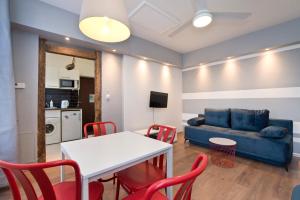 a living room with a table and chairs and a couch at Kawalerka Studio Stare Domki krr in Gdańsk