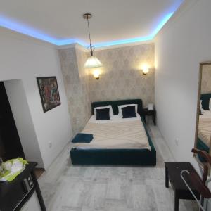 a bedroom with a bed and a blue light at Smart studio sibiu in Sibiu