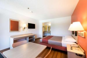 a small room with a bed and a desk at Motel 6-Sparks, NV - Airport - Sparks in Reno