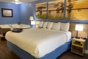 Una habitación de hotel con una cama grande y un baño. en Days Inn by Wyndham Fordyce, en Fordyce 11 fotos más