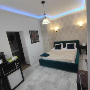 a bedroom with a bed with a blue ceiling at Smart studio sibiu in Sibiu