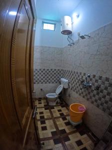 a bathroom with a toilet and a sink at Gaharwar Home Stay in Dehradun