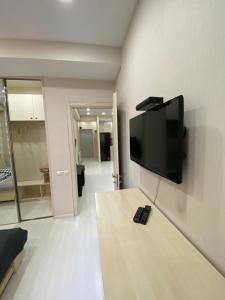 a living room with a television on a wall at Apartment Vake in Tbilisi City
