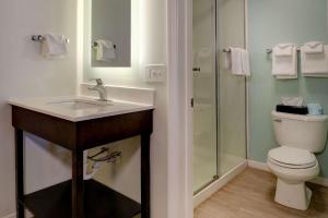 a bathroom with a sink and a toilet and a shower at Quality Inn & Suites in Lincoln