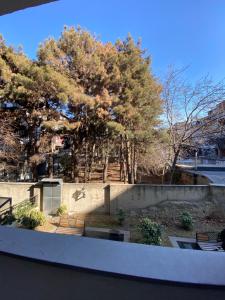 a view of a park with benches and trees at Apartment Vake in Tbilisi City