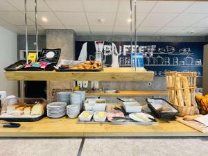 a buffet of food on display in a restaurant at ibis budget Amiens Centre Gare in Amiens