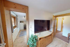 a bathroom with a large sink in a room at Julach Haus Apartment in Längenfeld