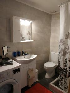 a bathroom with a white sink and a toilet at Seafront two-storey house in Kardamyla in Mármaron +53 photos