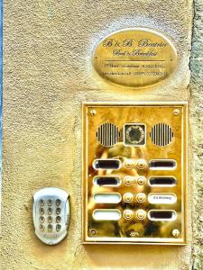 een gouden mobiele telefoon aan de zijkant van een muur bij B&Beatrice in Florence