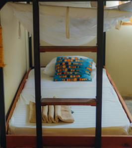 a bunk bed with a pillow on top of it at The Slow Leopard Kilwa in Kilwa Masoko