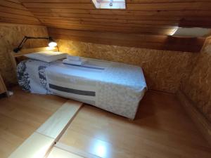 a bedroom with a bed in a room with wooden walls at Room Dream Beato in Lisbon