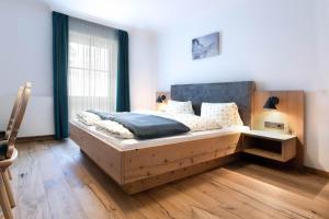 a bedroom with a large wooden bed in a room at Bauerndörfl Hüttschlag in Hüttschlag