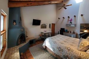 a bedroom with a bed and a fireplace at Casas de Suenos Old Town Historic Inn, Ascend Hotel Collection in Albuquerque