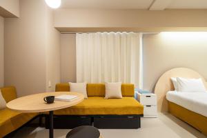 a room with a couch and a table and a bed at Section L Yushima-Ueno in Tokyo +23 photos