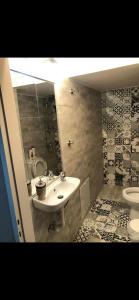 a bathroom with a sink and a toilet at Kapodistriou Apartments in Aegina Town +25 photos