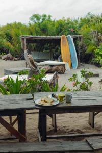 a picnic table with a plate of food on it at The Slow Leopard Kilwa in Kilwa Masoko