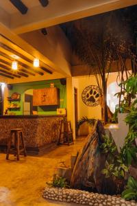 a kitchen with a counter and a tree in a room at The Slow Leopard Kilwa in Kilwa Masoko