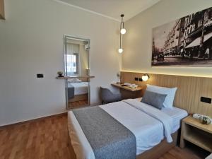 a bedroom with a bed and a desk and a mirror at Green Plaza Inn '''Business &Families Only''' in Alexandria