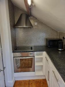 a kitchen with a stove and a microwave at Safire home in Murton
