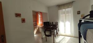 a bedroom with a table and chairs and a bed at Appartamento Vista Mare aA Briatico 15 Km Da Tropea Calabria in Briatico