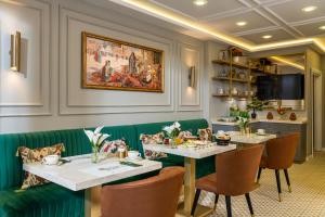 a dining room with two tables and green seats at Royan Suites in Istanbul