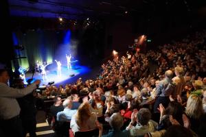 a crowd of people in an auditorium watching a concert at HALF PRICE OFFER - Exeter City Apartment in Exeter