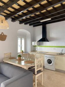 a kitchen and living room with a table and a couch at Conil Homes V Apartments in Conil de la Frontera
