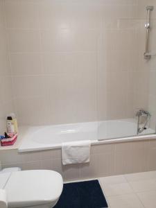 a bathroom with a white tub and a toilet at PENICHE - Guest House Casa das Estelas in Peniche +16 photos