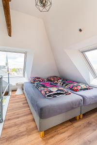 a bed in a room with two pillows on it at Authentic apartment in farmhouse near Amsterdam in Ilpendam