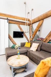 a living room with a couch and a table at Authentic apartment in farmhouse near Amsterdam in Ilpendam