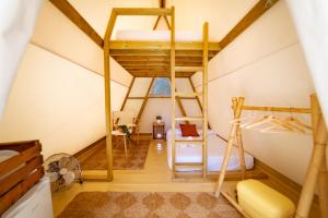 a room with a bunk bed and a ladder at Kampaoh Somo Parque Playa in Somo