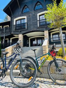 two bikes parked in front of a house at Dolina Wikingów-apartament typu Suite Deluxe z 16 m tarasem w ogrodzie, miejscem w garażu i dostępem do strefy Wellness in Szklarska Poręba
