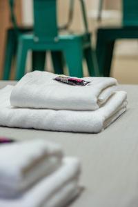 two towels sitting on a table with a pen on them at Gente del Sur - Finisterre B in Ushuaia