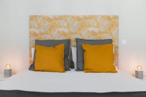 a white bed with yellow pillows and a headboard at Alegria Flat by An Island Apart in Funchal