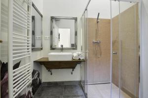 a bathroom with a sink and a shower at Golden Leaf Apartment in Budapest